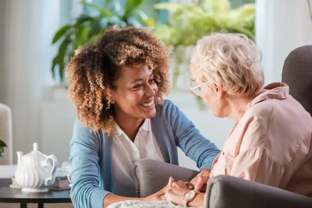 Companion caregiver sharing a smile with a senior woman